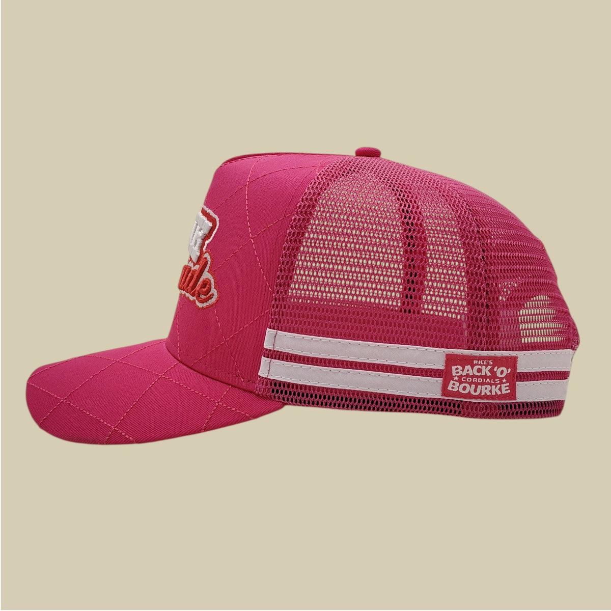 A pink trucker-style cap with a quilted front panel, mesh back, white stripe detail on the back strap, and embroidered branding on the side and back patch.