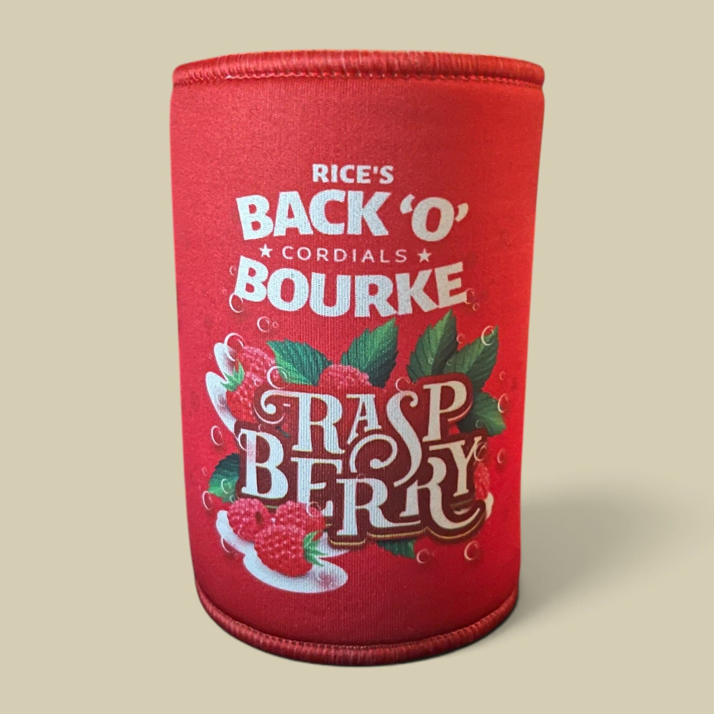 A red neoprene can cooler sleeve featuring a raspberry-themed graphic with the text 'RICE'S BACK 'O' CORDIALS BOURKE' and 'RASPBERRY' in large decorative lettering, shown on a plain beige background.